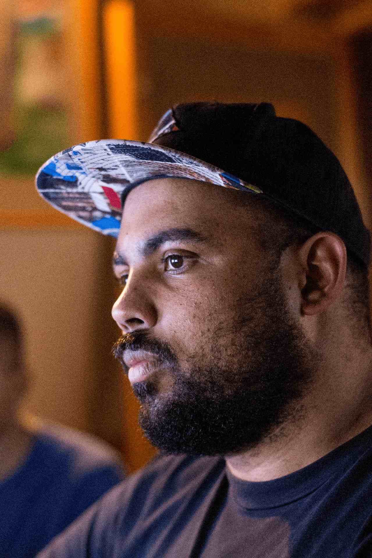 Portrait of el conductor in a warm studio setting.